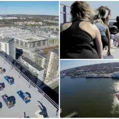 Grupp som utövar urban yoga på ett tak med utsikt över stad och hamn.