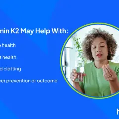 Kvinna tar ett piller och ett glas vatten. Vitamin K2 kan stödja benhälsa, hjärthälsa och blodkoagulering, en del av en holistisk hälsoresa.