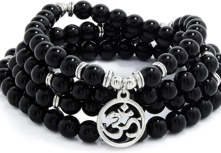 Ett vackert mala armband av svarta stenpärlor med ett silverfärgat Om-hänge. Perfekt för meditation och för att skapa inre lugn.