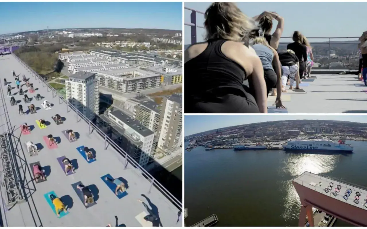 Grupp som utövar urban yoga på ett tak med utsikt över stad och hamn.